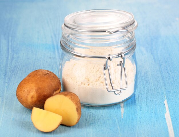 Starch in bank on wooden table closeup