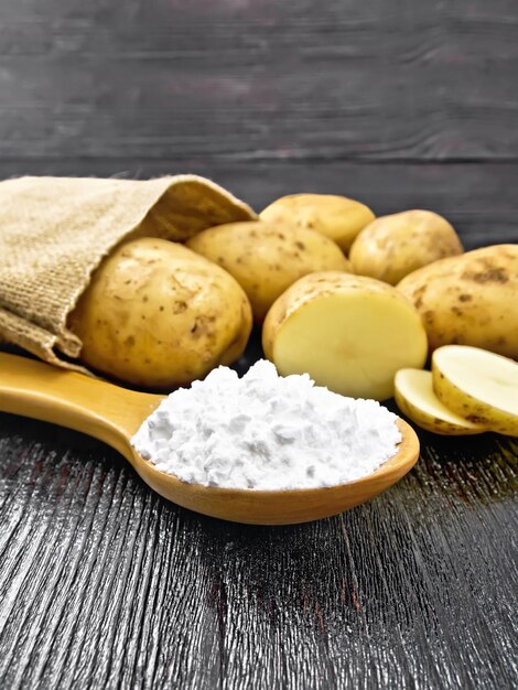 Starch potato in spoon on table