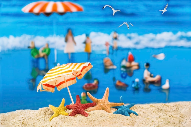 Starfish on beach on sand with sun umbrella
