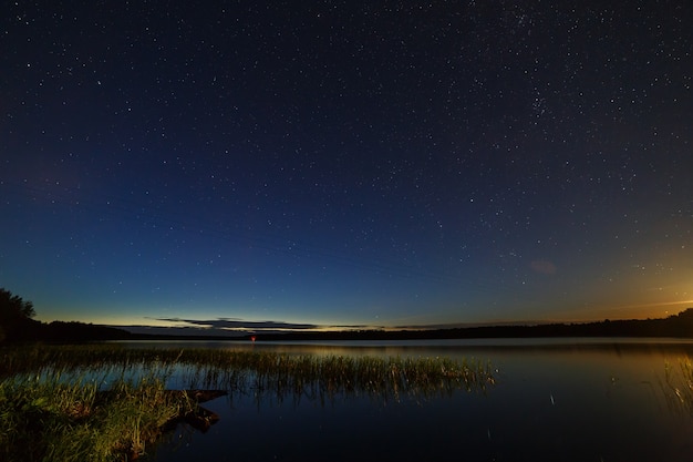 The stars in the night sky over the river.