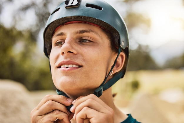 Start helmet and face of a man in nature fitness cycling and training for a sports competition in Australia Ready happy and biker with safety for cardio exercise workout and biking in a park