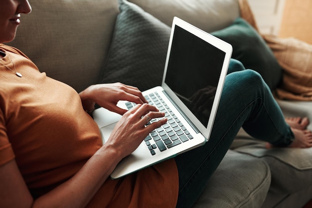 The start of a new online hobby Cropped shot of an unrecognizable woman using her laptop at home