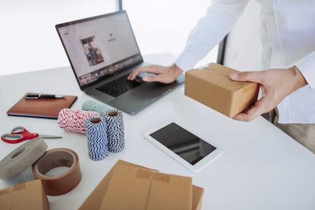 start up small business owner entrepreneur sme using laptop for online business in office room