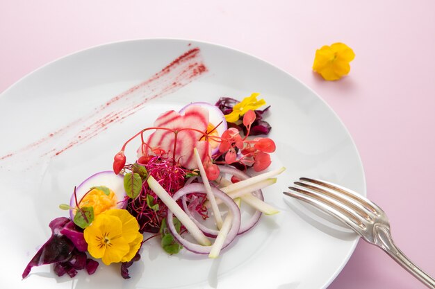 Starter with pink beetroot with yellow pansy flowers