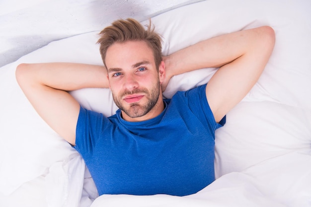 Starting his day with regular routine. Handsome guy awaken for morning routine. Sexy man lying in bed before grooming routine. The sacred routine man should be doing every morning.