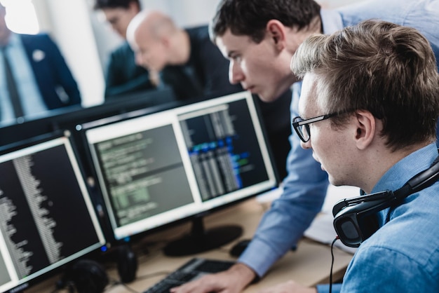 Startup business problem solving software developers working on desktop computer