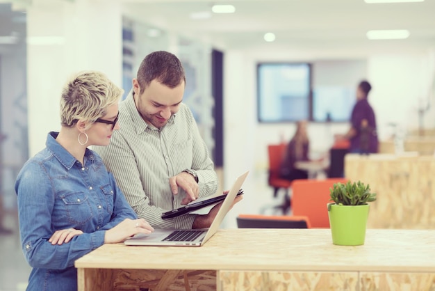 startup business team on meeting in modern bright office interior brainstorming, working on laptop and tablet computer