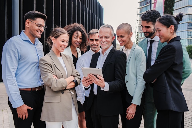 Startup business team talkingand using a tablet to share ideas on a briefing executive partners or