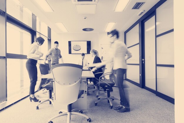 startup business  young creative  people group entering meeting room with motion blur  modern office interior