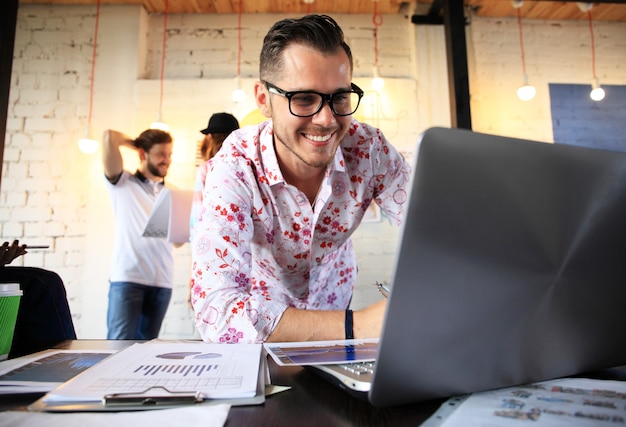 Startup diversity teamwork brainstorming meeting concept.business team coworker global sharing economy laptop graph screen.people working planning start up.group young man women looking report office.