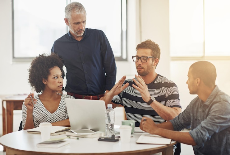 Photo startup laptop or people in conversation for planning ideas or strategy in meeting for teamwork development group or creative designers talking in collaboration for growth or support in workplace