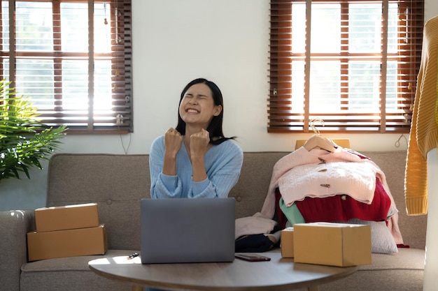Startup small business entrepreneur sme asian woman packing box\
portrait of young asian small business owner in home office online\
sell marketing delivery sme ecommerce telemarketing concept