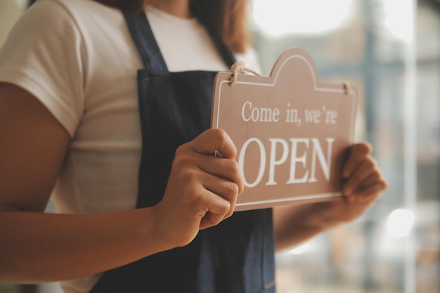startup successful small business owner sme beauty girl stand with tablet smartphone in coffee shop restaurant portrait of asian tan woman barista cafe owner sme entrepreneur seller business concept