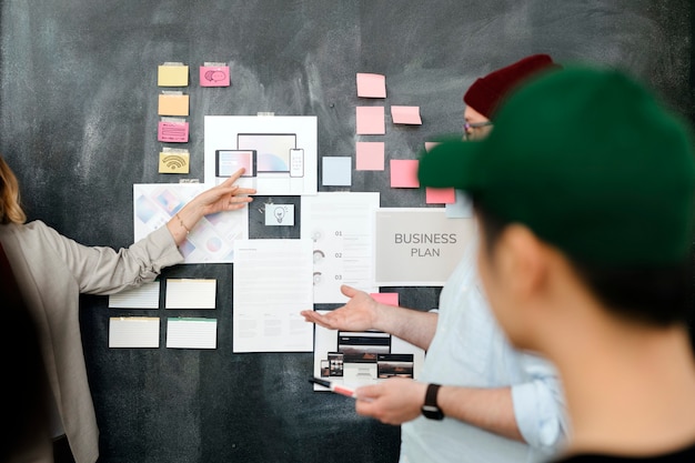 Startup team brainstorming in meeting room using blackboard