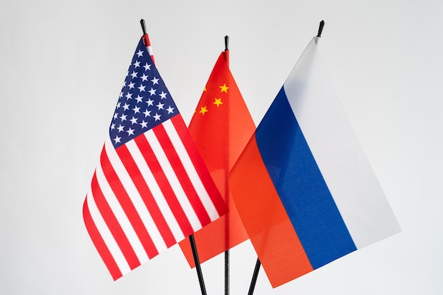 State flags of America Russia China on white background China flag behind Conflict concept