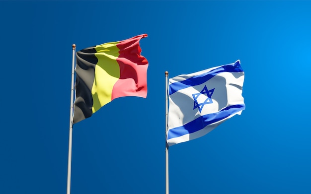 State flags of israel and belgium together on sky background