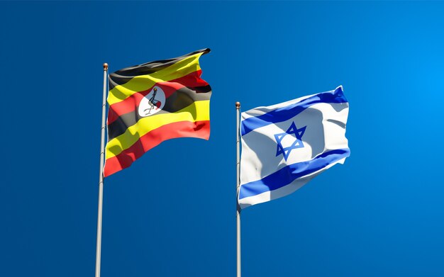 state flags of Uganda and Israel together on sky background