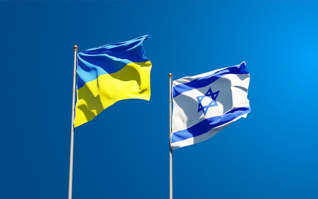 state flags of Ukraine and Israel together on sky background