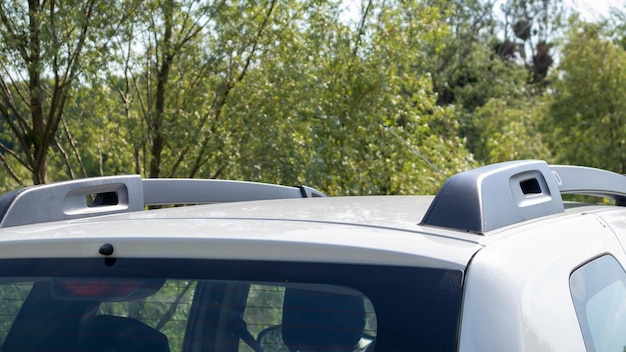 A station wagon roof rack for securing large loads or a cargo box. Travelling by car. Part installed on the roof of the vehicle.