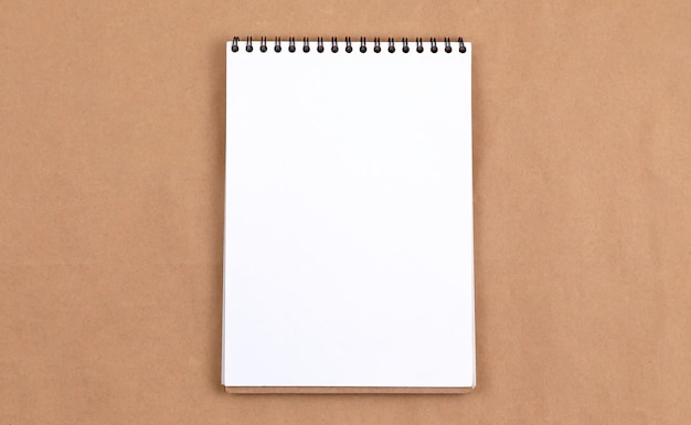 Photo stationary concept, flat lay top view photo of blank notepad on beige