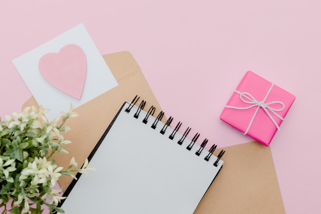 Stationary concept,  pencil, pen  and notepad  on a pink abstract table with copy space, minimal