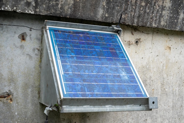 Stationary small solar panel on a concrete wall