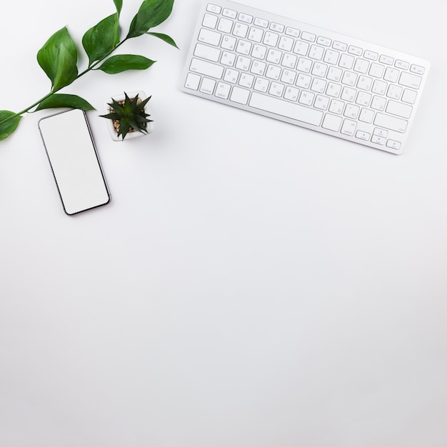 Stationery arrangement on white background with phone mock-up