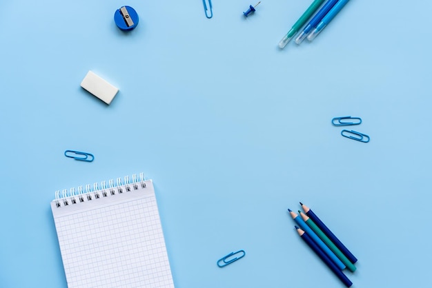 stationery on a blue background school supplies top view flat lay space for text