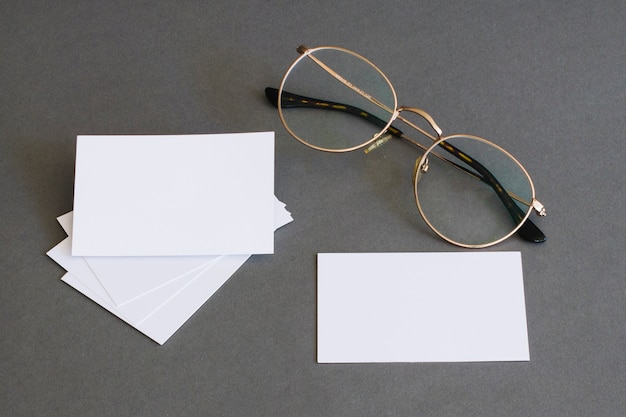 Photo stationery concept with business cards and glasses