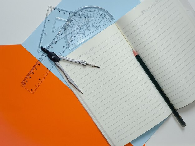 Stationery equipment compasses semicircles triangles notebooks rulers colored paper