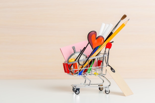 Stationery items in shopping trolley at left side