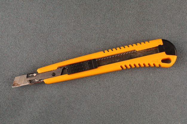 Stationery knife on a gray table