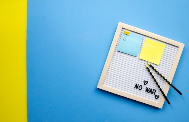 Stationery and letter board no war sign on blue background