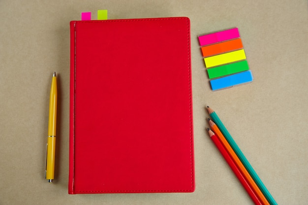 Stationery, notebook, pen, pencils on paper craft background