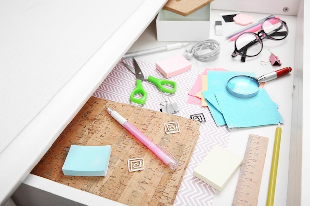Stationery in open desk drawer closeup