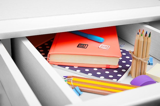 Stationery in open desk drawer closeup