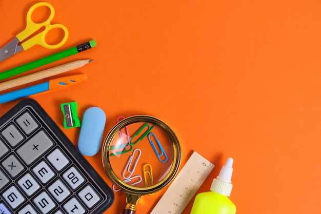 Stationery set for schoolboy orange backgroundPreparing for school season