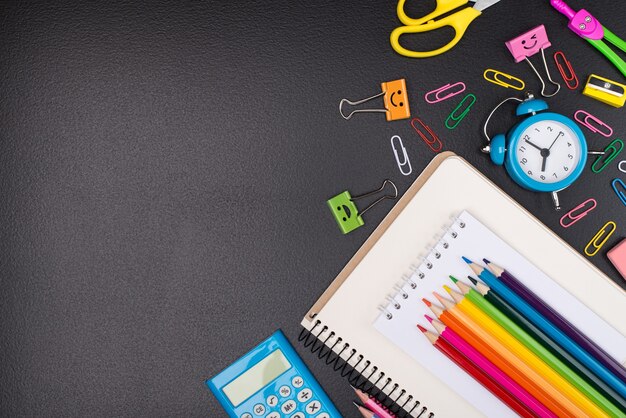 Stationery shopping concept. Top above overhead view photo of colorful stationery isolated on blackboard