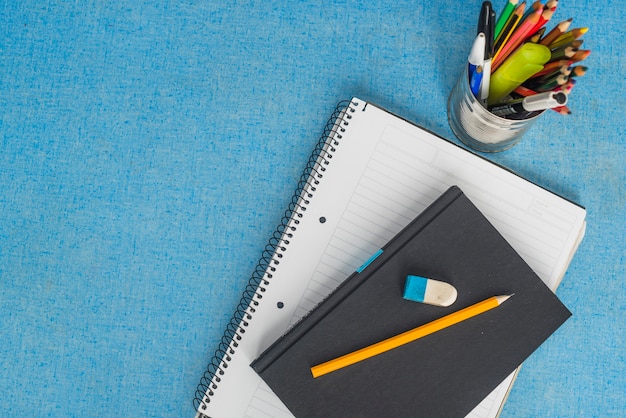 Stationery and textbook on blue