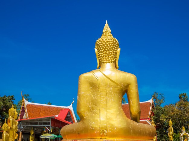 Statue against blue sky and building