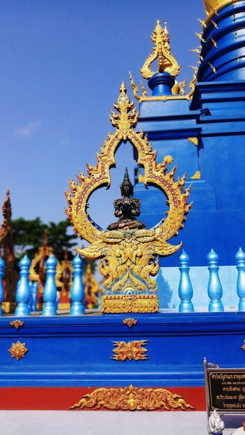 Statue against blue sky and building