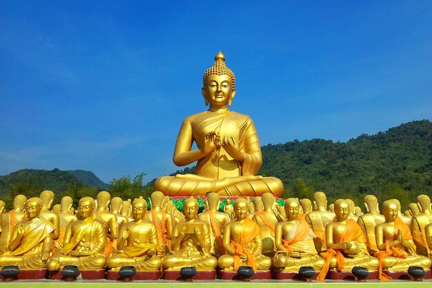 Statue against temple against sky