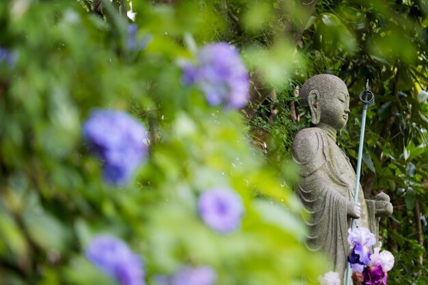 Statue amidst flowers