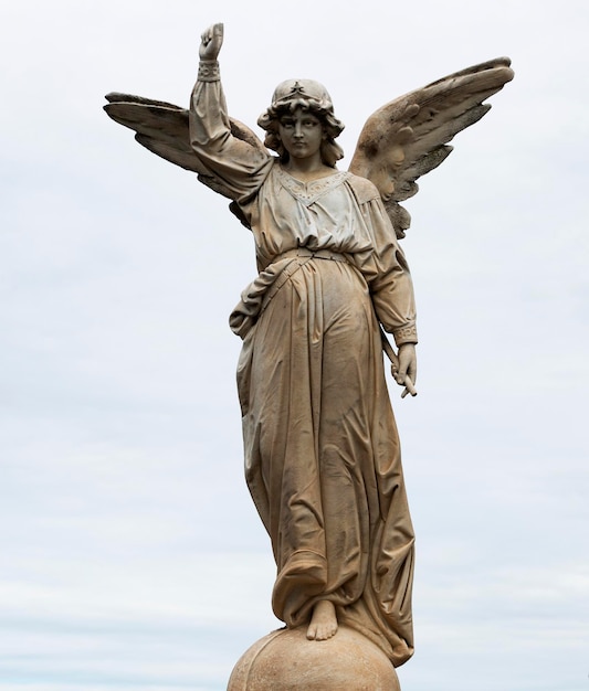 A statue of an angel with an arrow in the center of her hand.