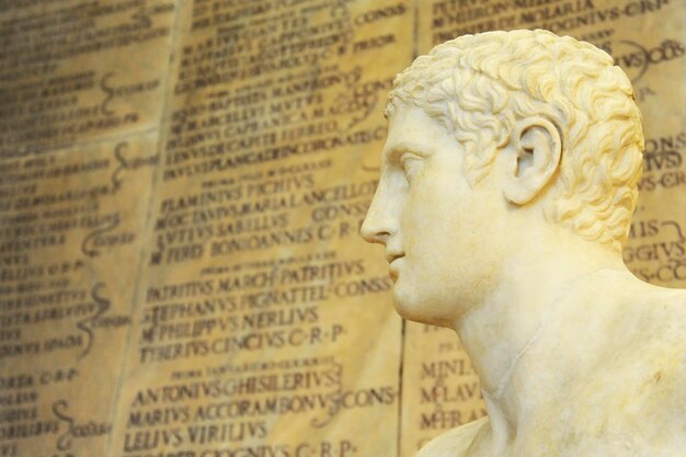 Statue of an athlete On background some ancient roman inscription blurred Rome Italy