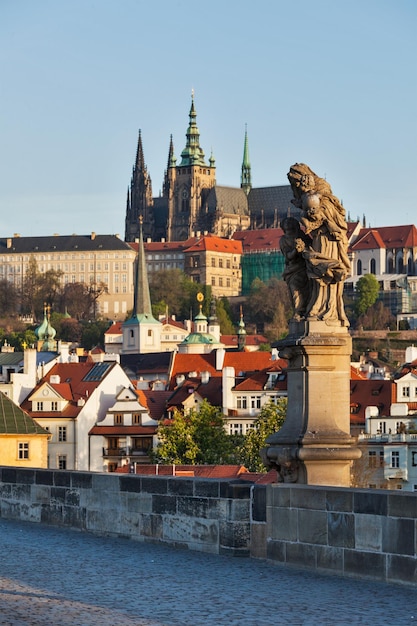 Statue on Charles Brigde against St Vitus Cathedral in Prague