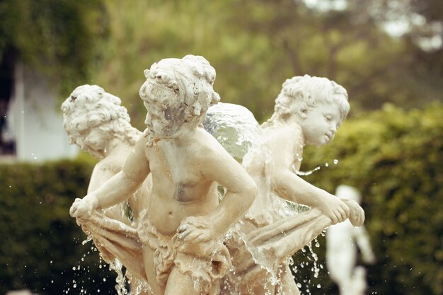 Statue of children at the top of the fountain