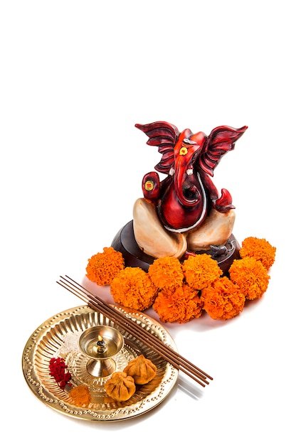 Statue of Hindu God Ganesha, Worship arrangement on white background.