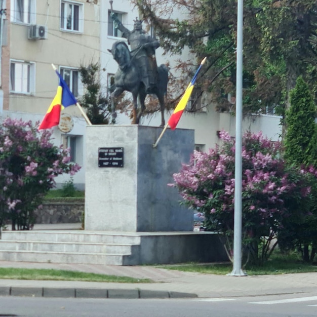 A statue of a horse and a flag with the word " no " on it.