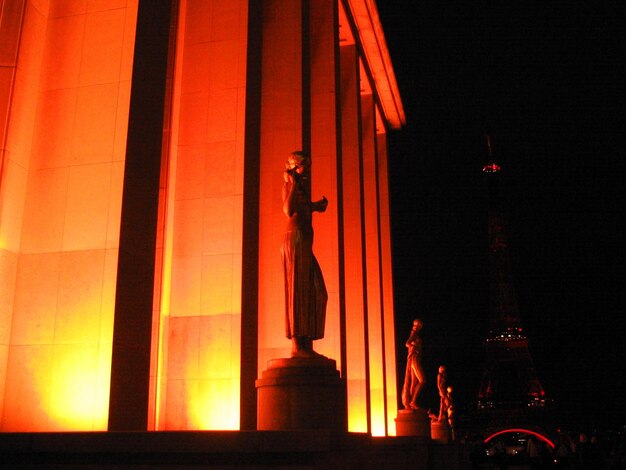 Statue of illuminated building at night